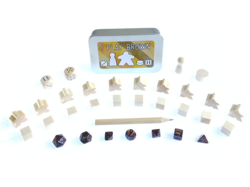 The Ultimate Board Game Survival Kit - A small tin with board game components in brown, 10 x meeples, 10 x cubes, 2 x D6 dice, 1 x pawn, 1 x cylinder, 1 x pencil, 7 piece mini dice set